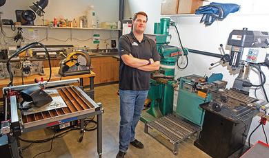 Robert Monteith, analytical instrumentation engineer, stands inside the Academic Machine Shop. 
